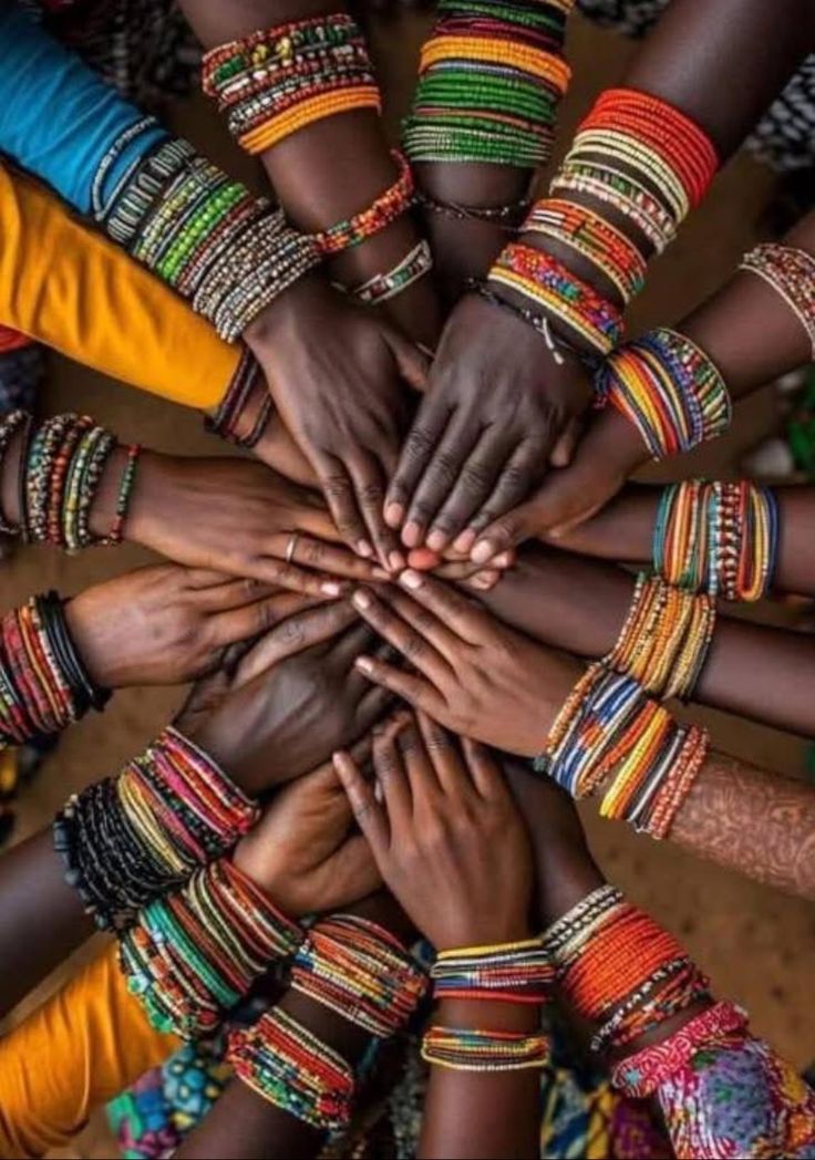 Hands adorned with traditional beaded bracelets, symbolising Nigerian community and diversity