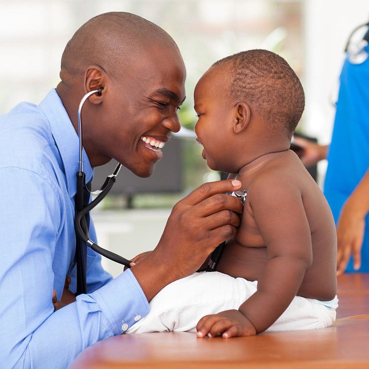 Nigerian healthcare professional caring for a young patient